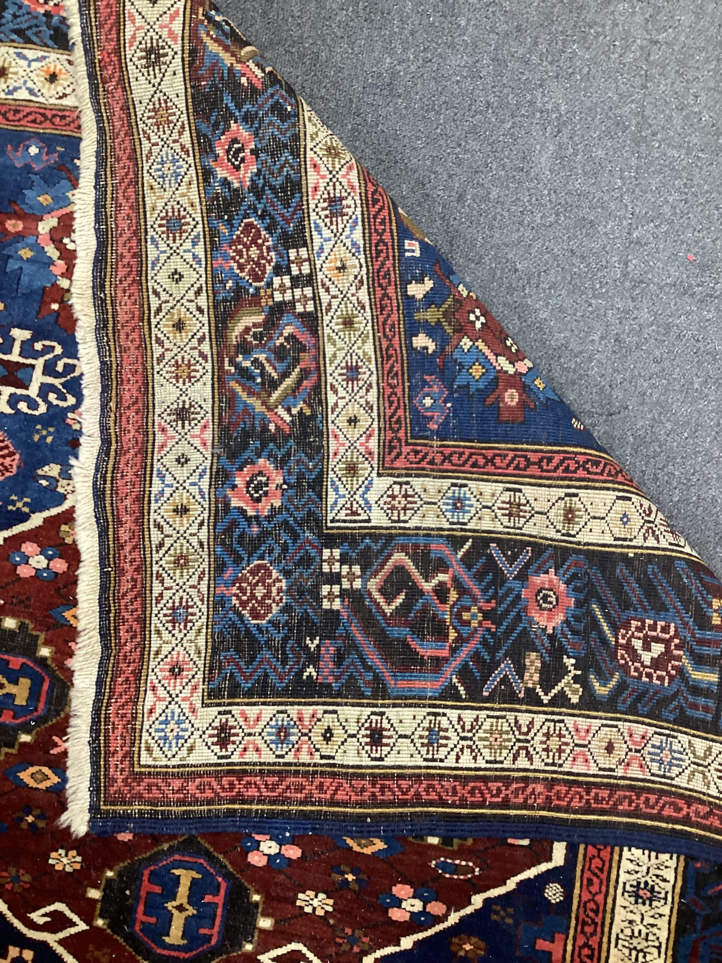 A South Caucasian blue ground runner, the field woven with five red lozenge panels, 390 x 118cm